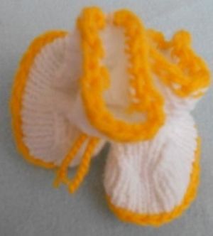 Ръчно плетени терлички  за новородено - бяло с жълто